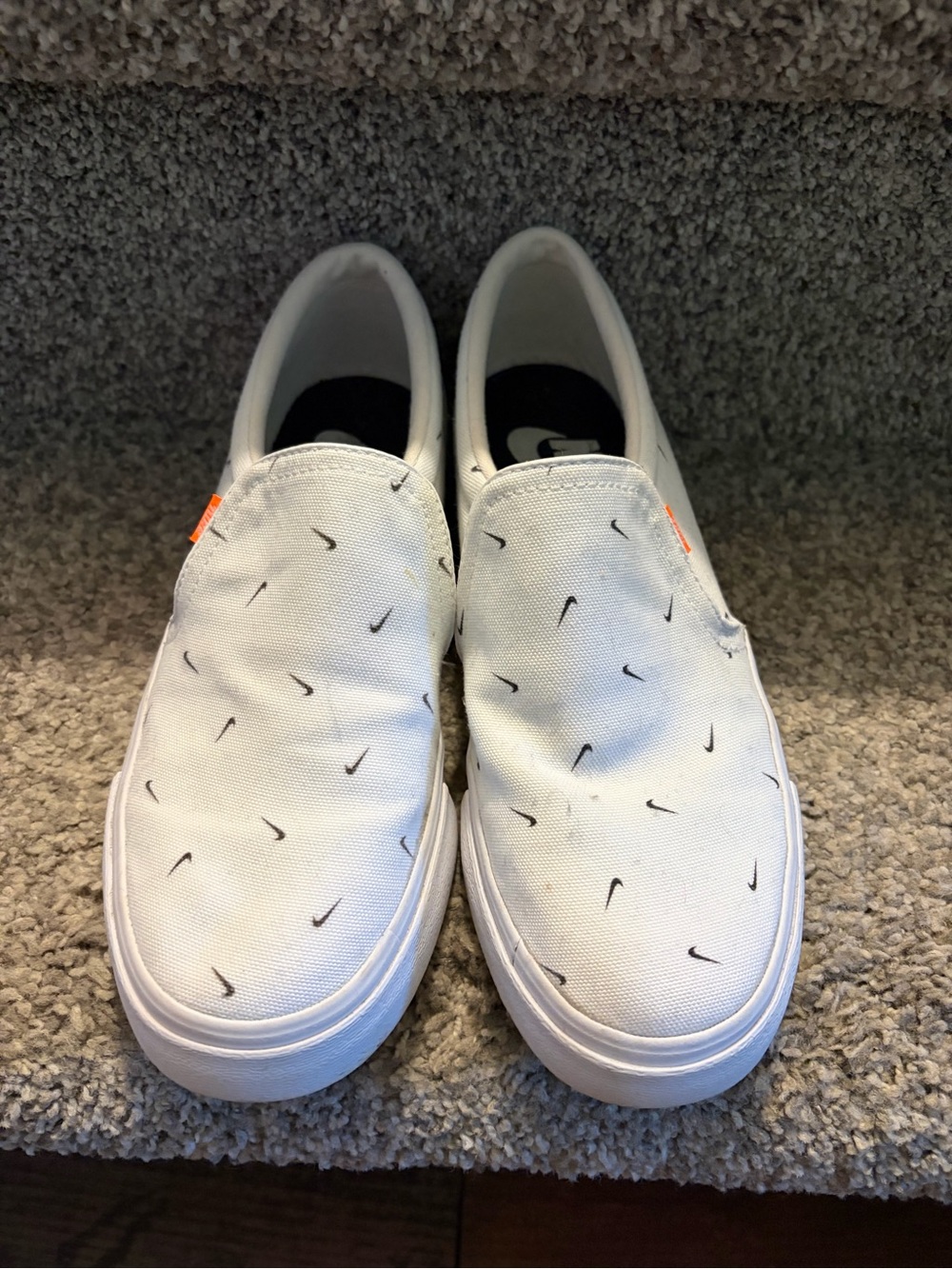 Nike White Slip-Ons with Mini Black Swoosh Print